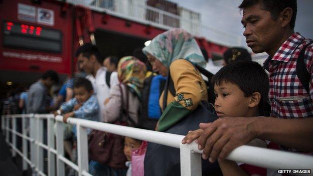 Migrants wait to board Athens ferry in Kos, Greece, on 4 June 2015