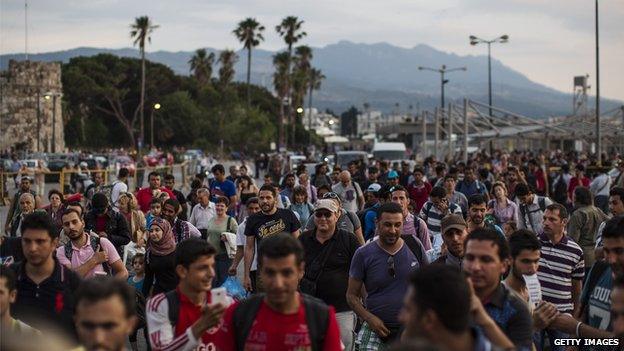 Migrants wait to board Athens ferry in Kos, Greece, on 4 June 2015