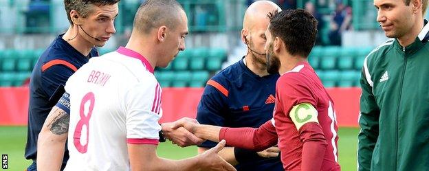 Scotland captain Scott Brown shakes hands with Qatar counterpart Hassan Khalid H Alhaydos