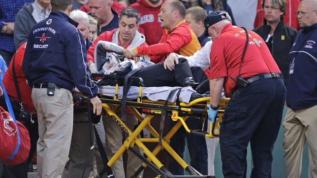 A female fans receives treatment during a game between Boston Red Sox and Oakland Athletics