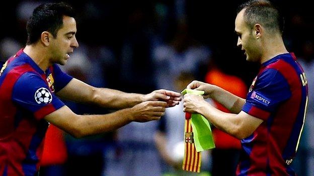 Barcelona"s Andres Iniesta hands over the captain"s armband as he is substituted by Xavi