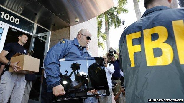 FBI agents carry boxes and computers from the headquarters of CONCACAF after it was raided on May 27, 2015 in Miami Beach, Florida