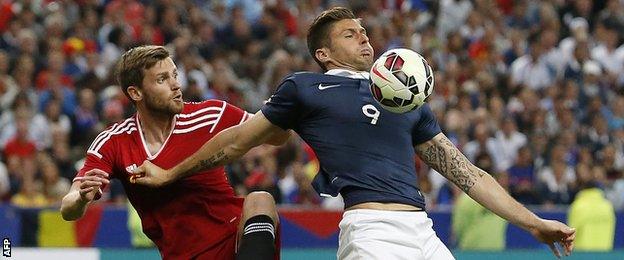 France's Olivier Giroud tries to fend of Belgium defender Nicolas Lombaerts