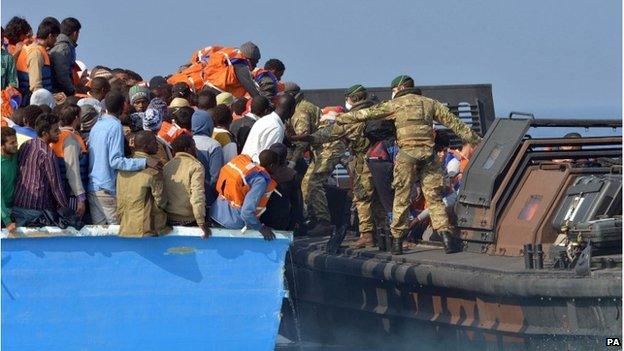 Royal Marines from HMS Bulwark help rescue migrants stranded on a boat, thirty miles off the Libyan coast.