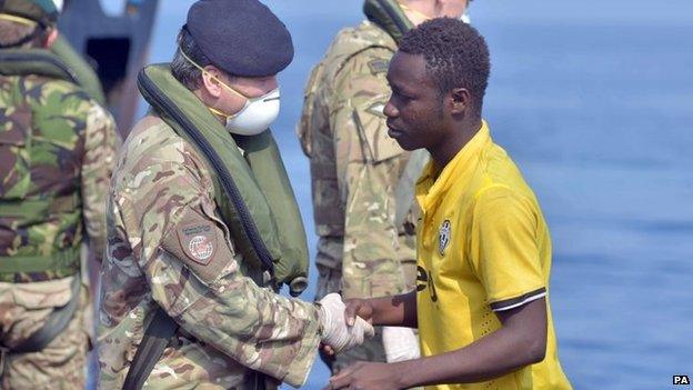 Royal Marines from HMS Bulwark help rescue migrants stranded on a boat, thirty miles off the Libyan coast