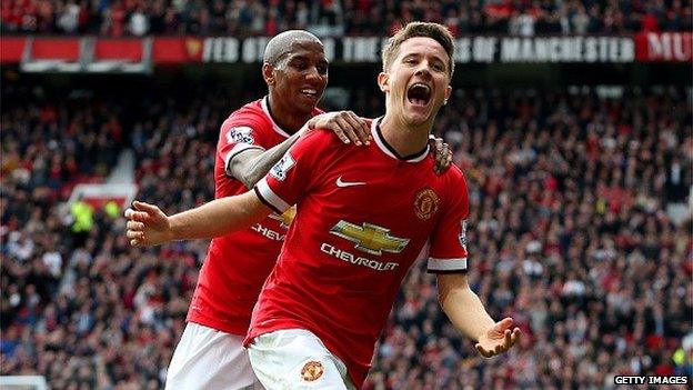 Ander Herrera of Manchester United celebrates with team-mate Ashley Young of Manchester United after scoring the opening goal during the Barclays Premier League match between Manchester United and Aston Villa at Old Trafford on April 4, 2015 in Manchester, England.