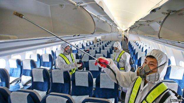 Employees from Korean Air disinfect the interior of its airplane in Incheon, South Korea, 5 June 2015