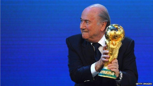 FIFA President Joseph S Blatter holds the world cup trophy, 2 December 2010