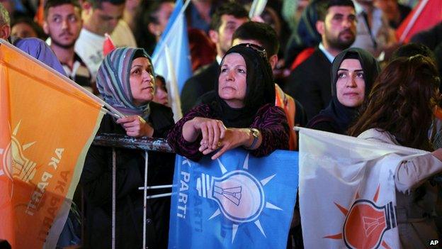 Supporters listen to Turkey's Prime Minister and leader of the ruling Justice and Development Party Ahmet Davutoglu as he speaks from the balcony of his party in Ankara, Turkey, late Sunday, June 7, 2015.