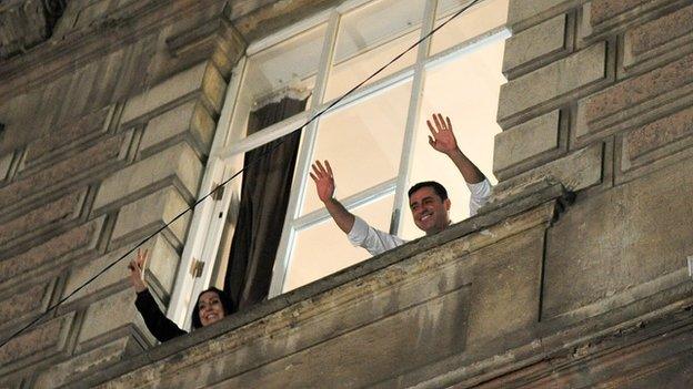 Selahattin Demirtas (R) and Figen Yukseldag (L), co-chairs of the pro-Kurdish HDP, wave to supporters in Istanbul on June 7, 2015