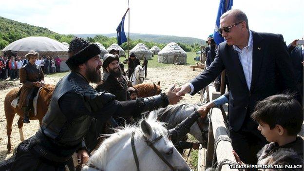 Turkish President Recep Tayyip Erdogan (R) shakes hands with actors during a visit to the set of the TV series "Dirilis" in Istanbul, Turkey, in this June 7, 2015 handout photo