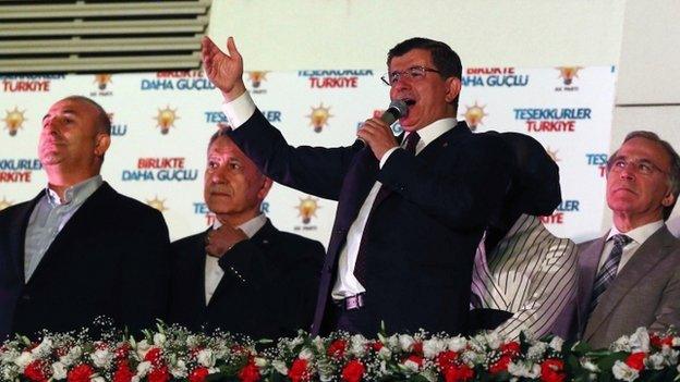 Turkish Prime Minister Ahmet Davutoglu addresses supporters and militants of the Justice and Development Party (AKP) from the balcony of the Justice and Development Party headquarters