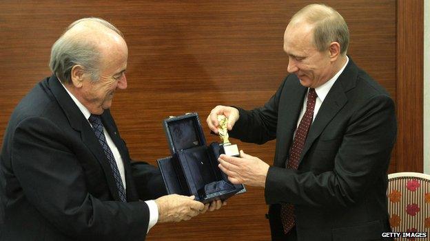 FIFA President Joseph Blatter (L) watches as Russian Prime Minister Vladimir Putin handles a replica of the World Cup 22 January 2010.