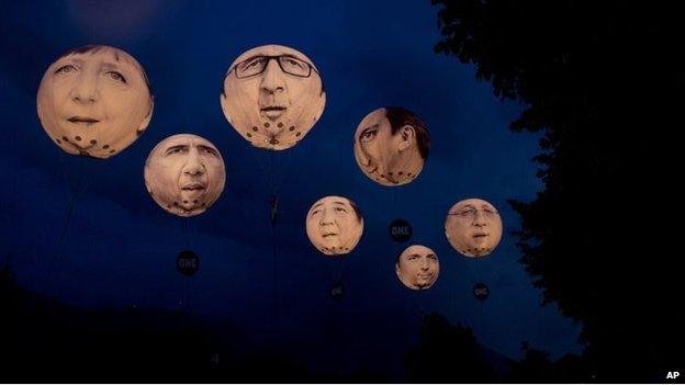 Giant inflatable balloons of G-7 leaders hang in the air at night in Garmisch-Partenkirchen, southern Germany (June 7, 2015)