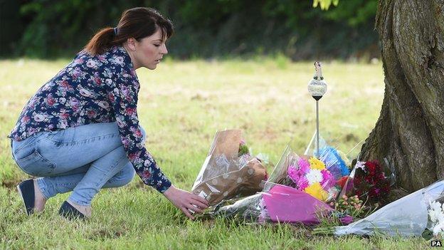 Woman leaves flowers as tribute for Amber Peat