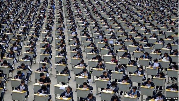 Students take an examination on an open-air playground at a high school in Yichuan, Shaanxi province 11 April 2015.