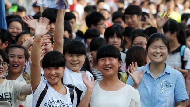 This picture taken on 8 June 2015 shows high school students walking out of a school after sitting the 2015 national college entrance examination, or the Gaokao, in Bozhou, east China's Anhui province