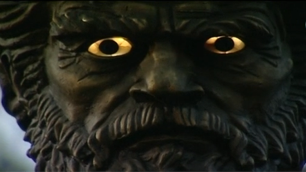 A close up of the Tsar's face with glowing eyes