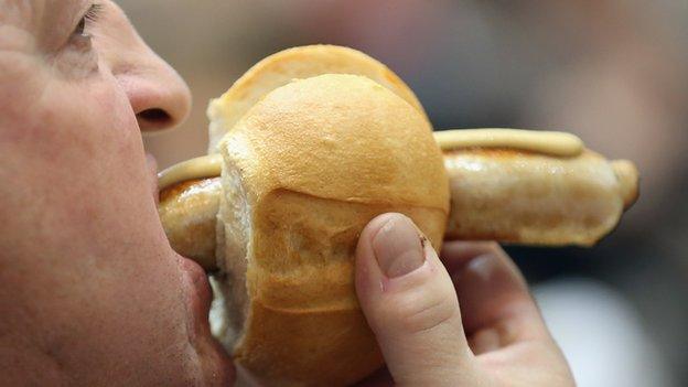 German man eating Bratwurst - file pic