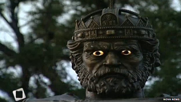 A close up of the Tsar's face with glowing eyes