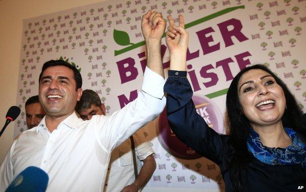 Selahattin Demirtas, left, co-chair of the pro-Kurdish Peoples' Democratic Party, (HDP) and Figen Yuksekdag, the other co-chair celebrate following a news conference in Istanbul, Turkey, 7 June 2015