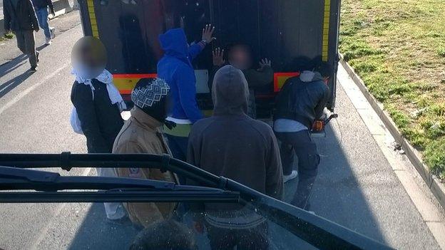 Migrants trying to access a truck