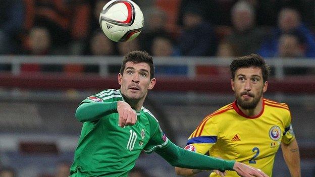 Northern Ireland's Kyle Lafferty battles with Romania's Paul Papp last November