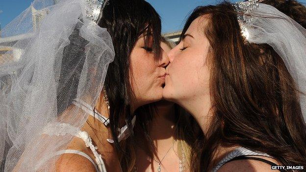 Lesbians Loren Cowley (L) and Michelle Ricketts seal their vows with a kiss outside the ruling Labor Party's conference during a mass 'illegal wedding' in Sydney on August 1, 2009.