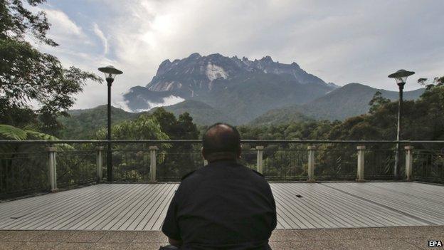 A policeman sits facing the Kinabalu Mountain as a rescue mission continues for more than 130 climbers stranded on one of Southeast Asia"s highest mountains after an earthquake, Sabah, in Kundasang, Malaysia, 6 June 2015.