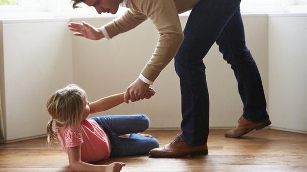 Father smacking his daughter