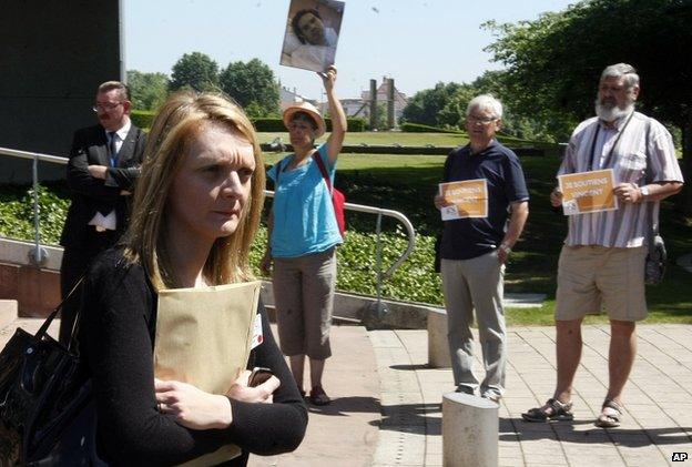 Rachel Lambert, wife of Vincent Lambert, passes by members of a committee supporting Vincent Lambert's mother as she leaves the European Court of Human Rights in Strasbourg, eastern France, Friday, 25 June 2015.