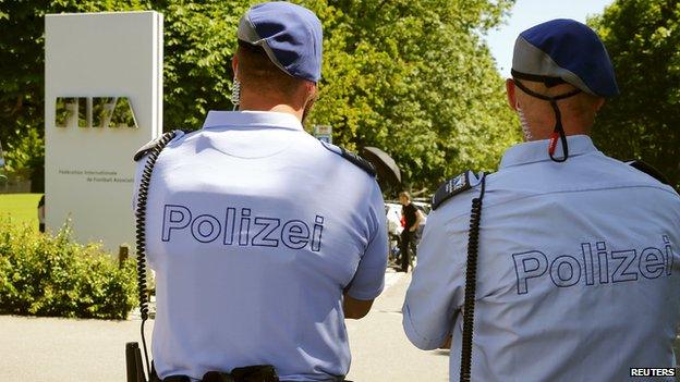 Swiss police officers stand in front of the entrance of the FIFA headquarters in Zurich, Switzerland on 3 June