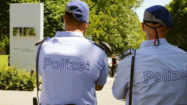 Swiss police officers stand in front of the entrance of the FIFA headquarters in Zurich, Switzerland on 3 June