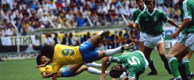 Socrates watches on as Careca takes a tumble during the 1986 World Cup match against Northern Ireland