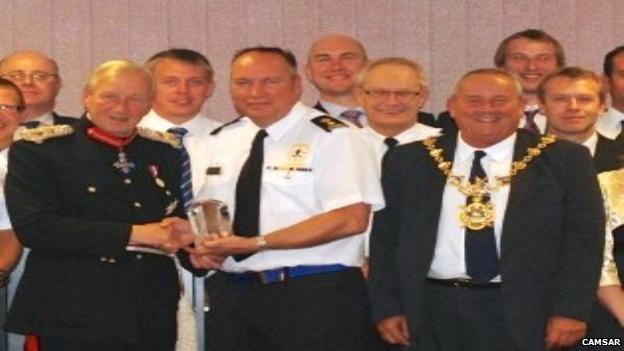 Paul Arnill receiving CamSAR's Queen's Award for Voluntary Service from Hugh Duberly