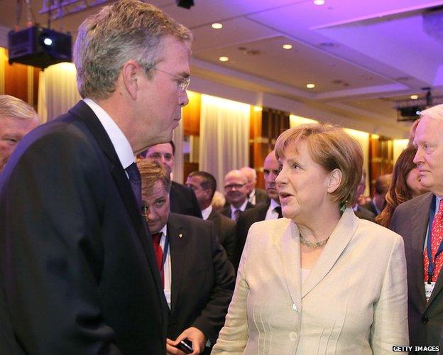 Jeb Bush speaks with German Chancellor Angela Merkel.