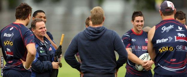 Sydney Roosters players listen to Brian Smith