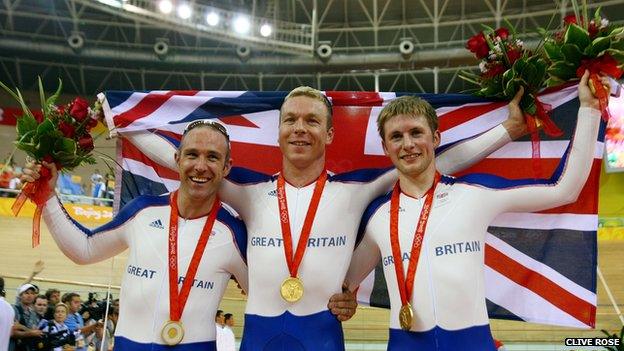 Jamie Staff, Chris Hoy, and Jason Kenny celebrate winning gold in the men's team sprint final at the 2007 Beijing Olympics