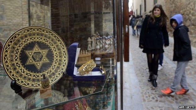 People standing near a gift shop in the old Jewish Quarter of Toledo in Spain