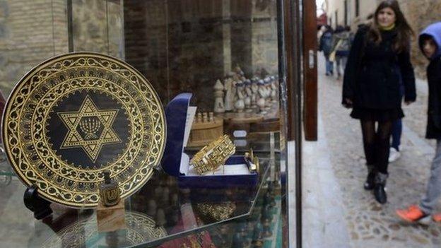 Peoplestanding near a gift shop in the old Jewish Quarter of Toledo in Spain