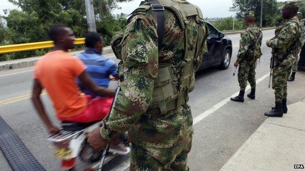 A Colombian soldier stands guard