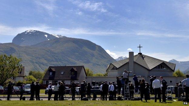 Media gather outside the church