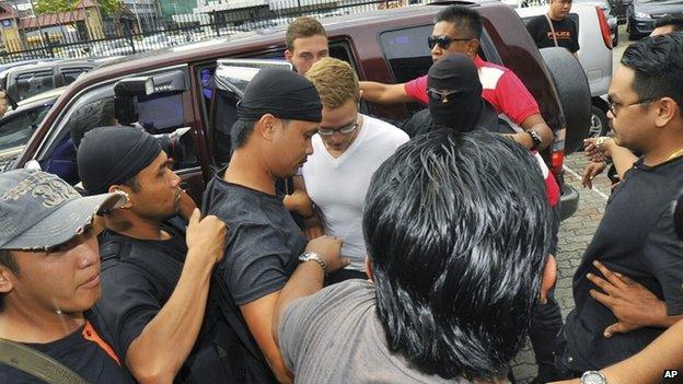 A defendant arrives at court