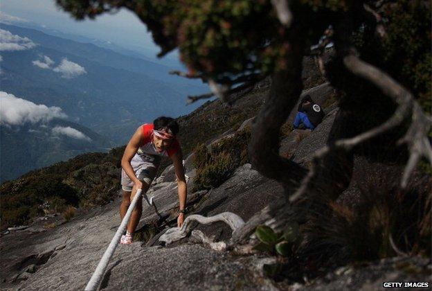 A participant runs through the gruelling course during the 2013 Mount Kinabalu Climbathon on 19 October 2013 in Kundasang, Sabah, Malaysia.