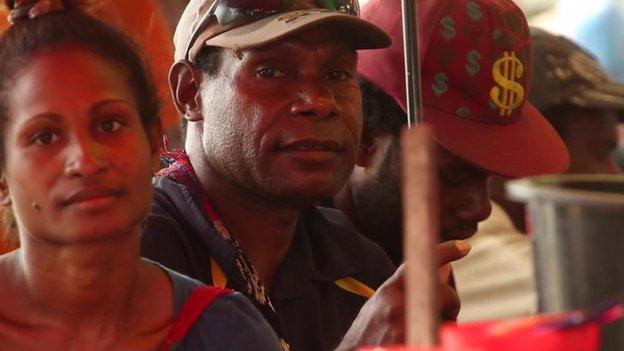 People waiting at a market in Papua New Guinea