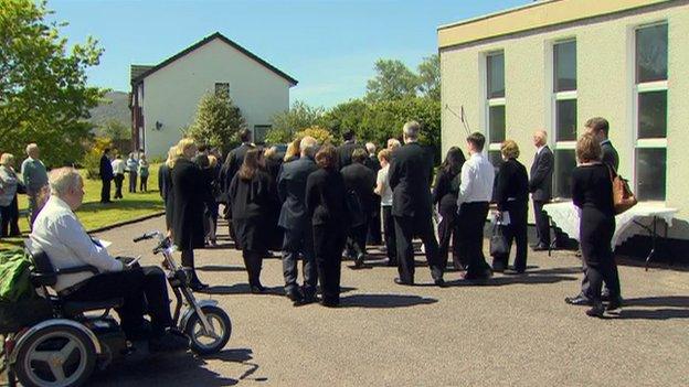 Mourners follow coffin