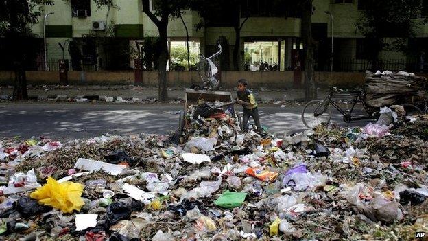 A young boy amid mountains of garbage in New Delhi