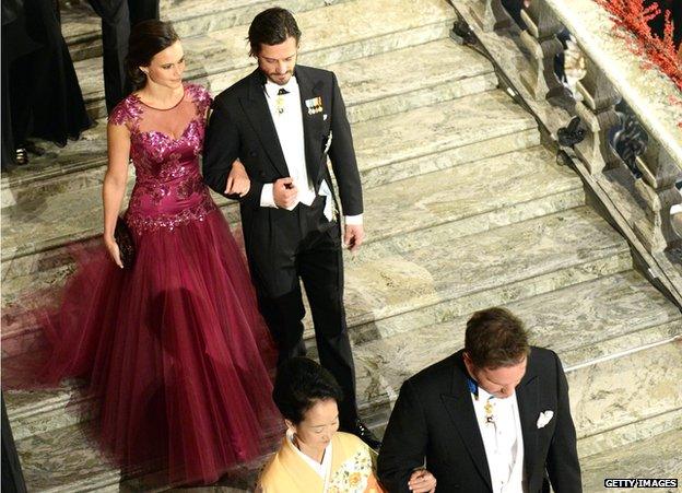 Prince Carl Philip of Sweden (right) and his fiancee Sofia Hellqvist arrive at the Nobel banquet at the Stockholm City Hall on 10 December 2014.