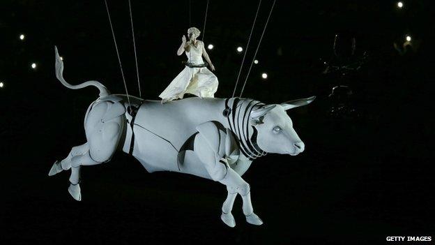 A performer rides a white bull at the opening of the European Games