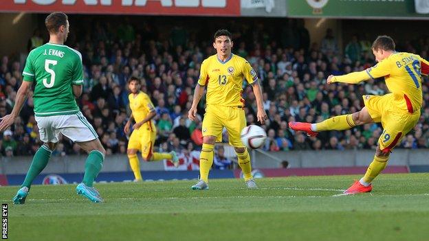 Jonny Evans attempts to block Andrei Prepelita's shot at Windsor Park